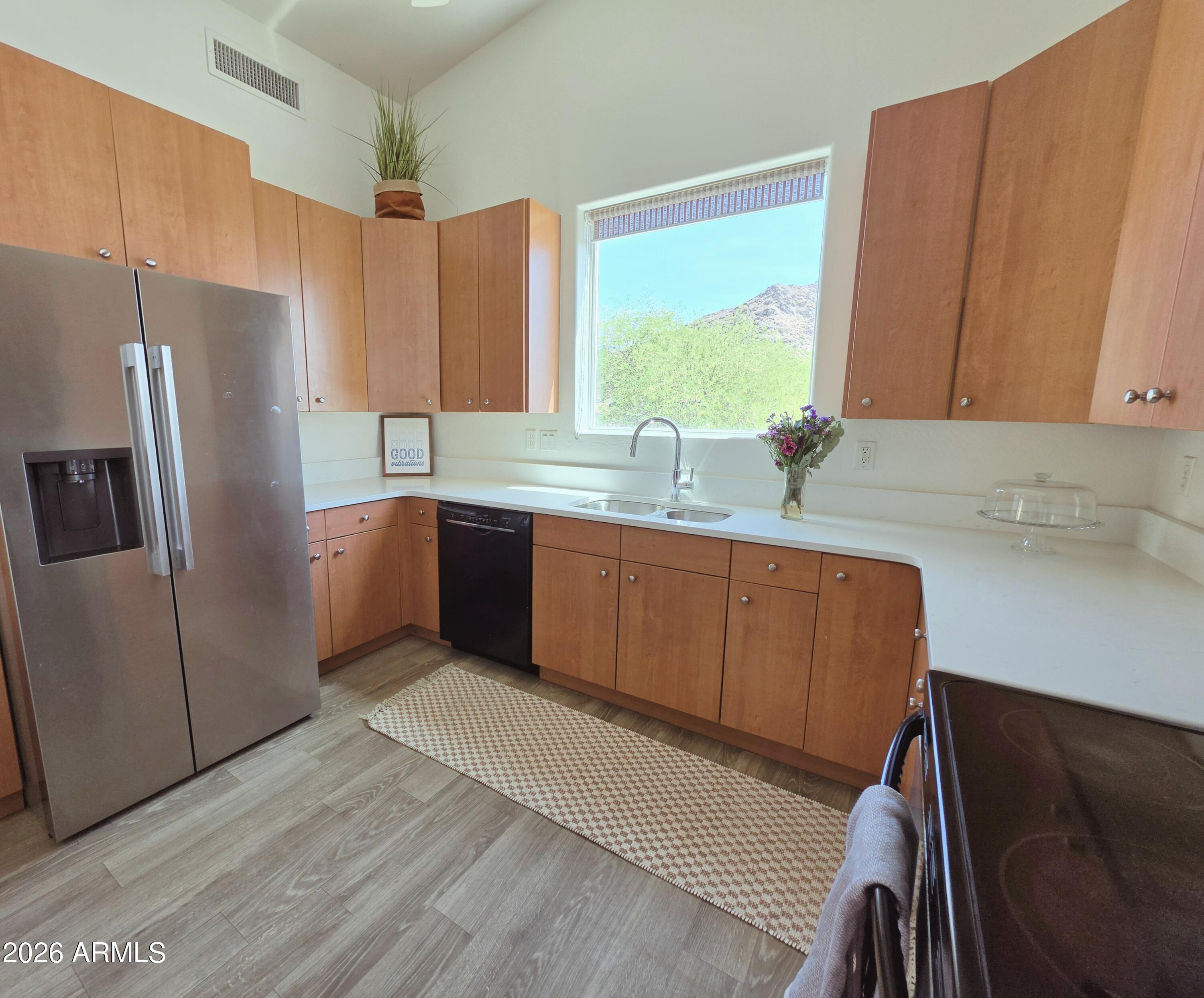 933 West Mercer Lane Phoenix, AZ 85029 - Photo 24 of 46 a kitchen with stainless steel appliances granite countertop a sink refrigerator and cabinets