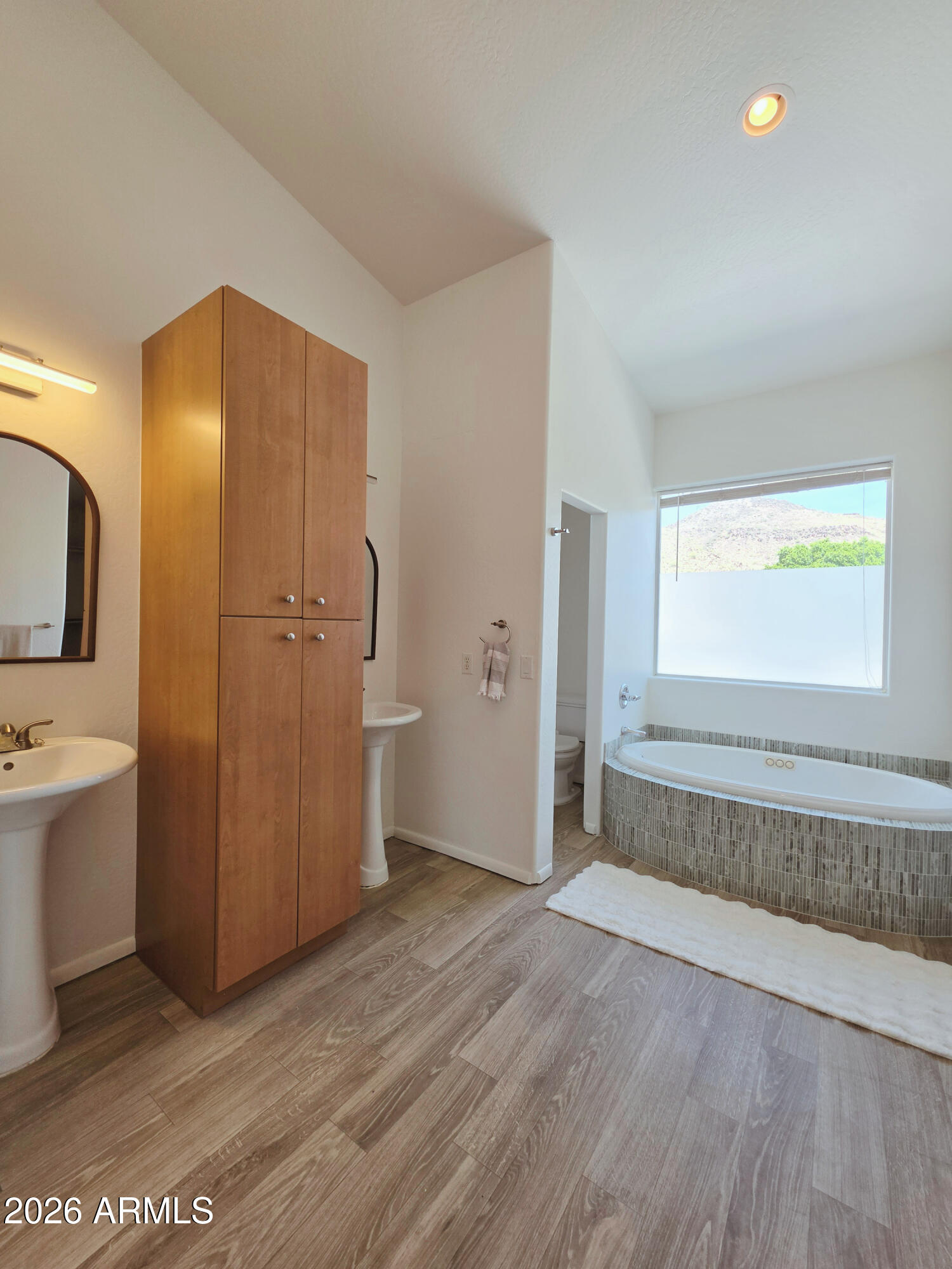 933 West Mercer Lane Phoenix, AZ 85029 - Photo 32 of 46 a view of an empty room with window and wooden floor