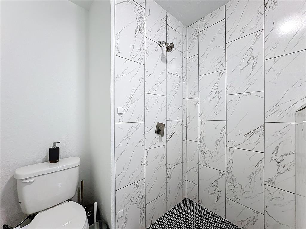 216 Obrien Road Casselberry, FL 32730 - Photo 11 of 22 a bathroom with a toilet and a shower curtain