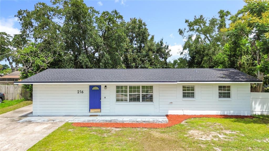 216 Obrien Road Casselberry, FL 32730 - Photo 2 of 22 a front view of a house with a yard and garage