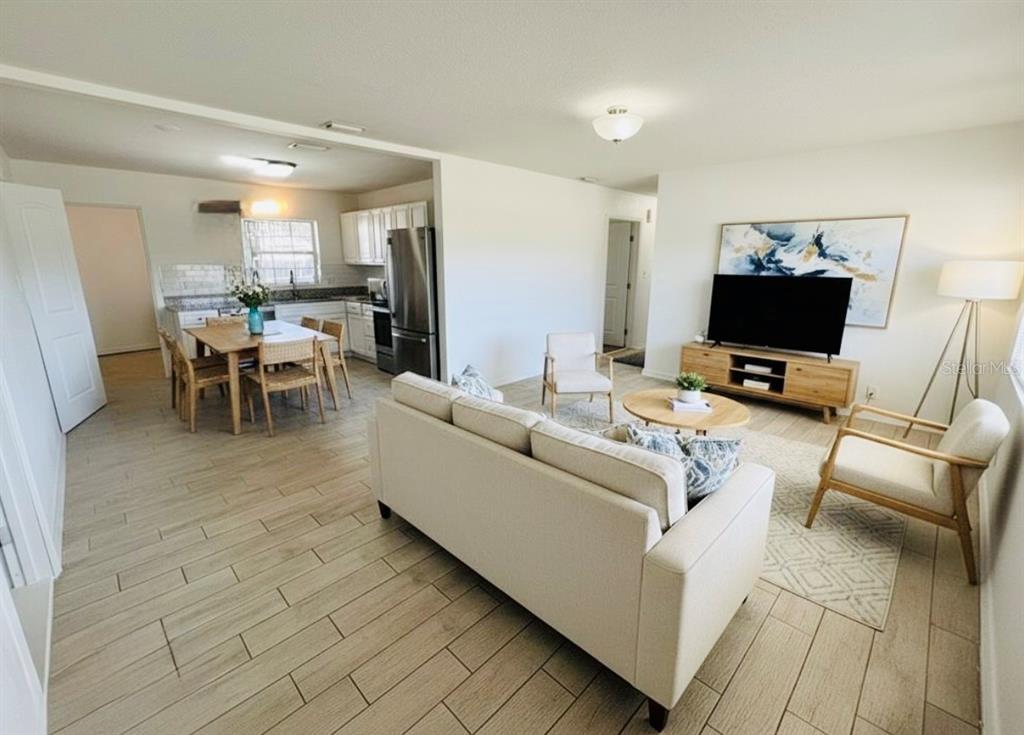 216 Obrien Road Casselberry, FL 32730 - Photo 6 of 22 a living room with furniture and a flat screen tv