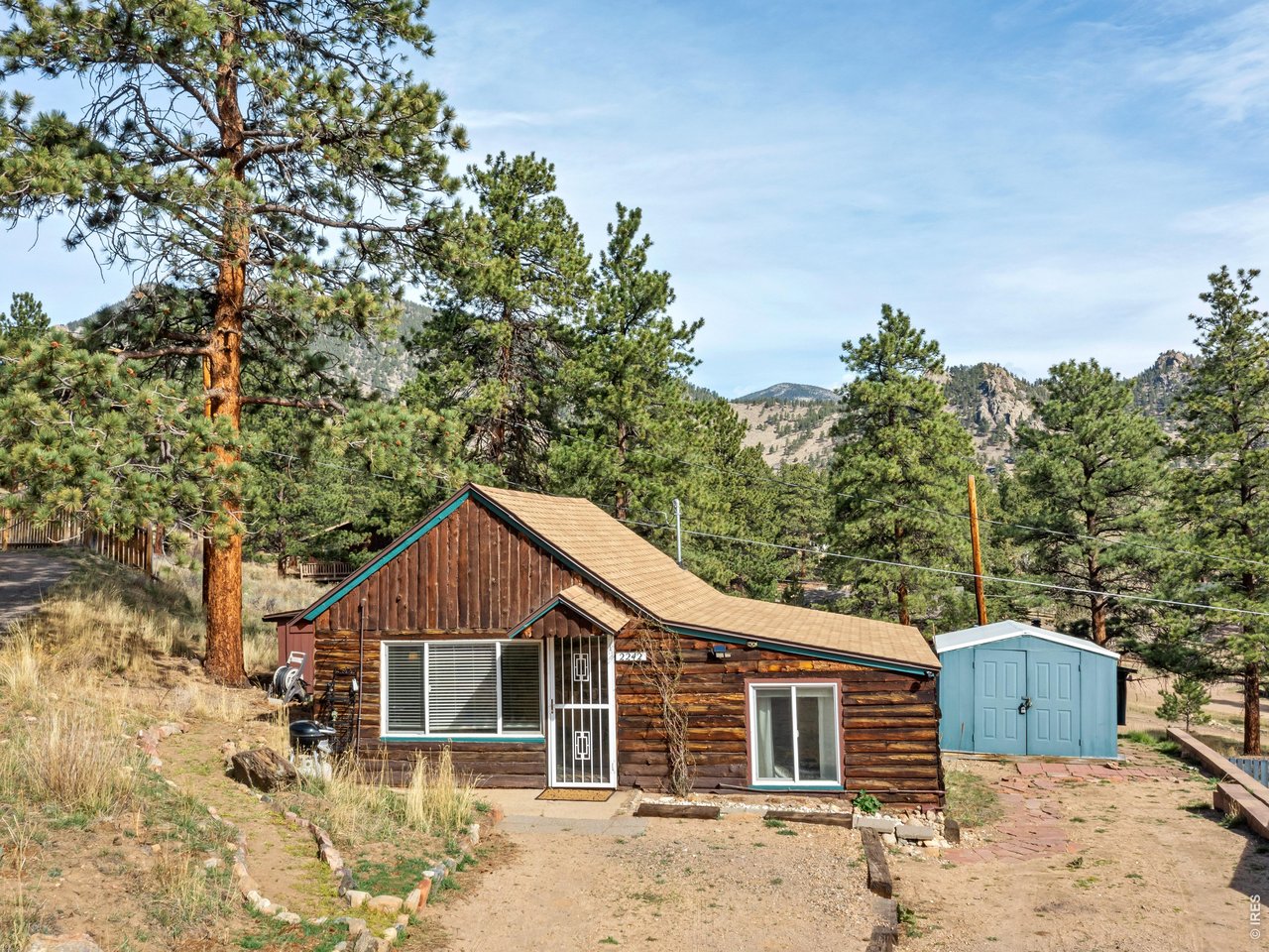 2242 Eagle Cliff Road Estes Park, CO 80517 - Photo 1 of 22 a front view of a house with a garden