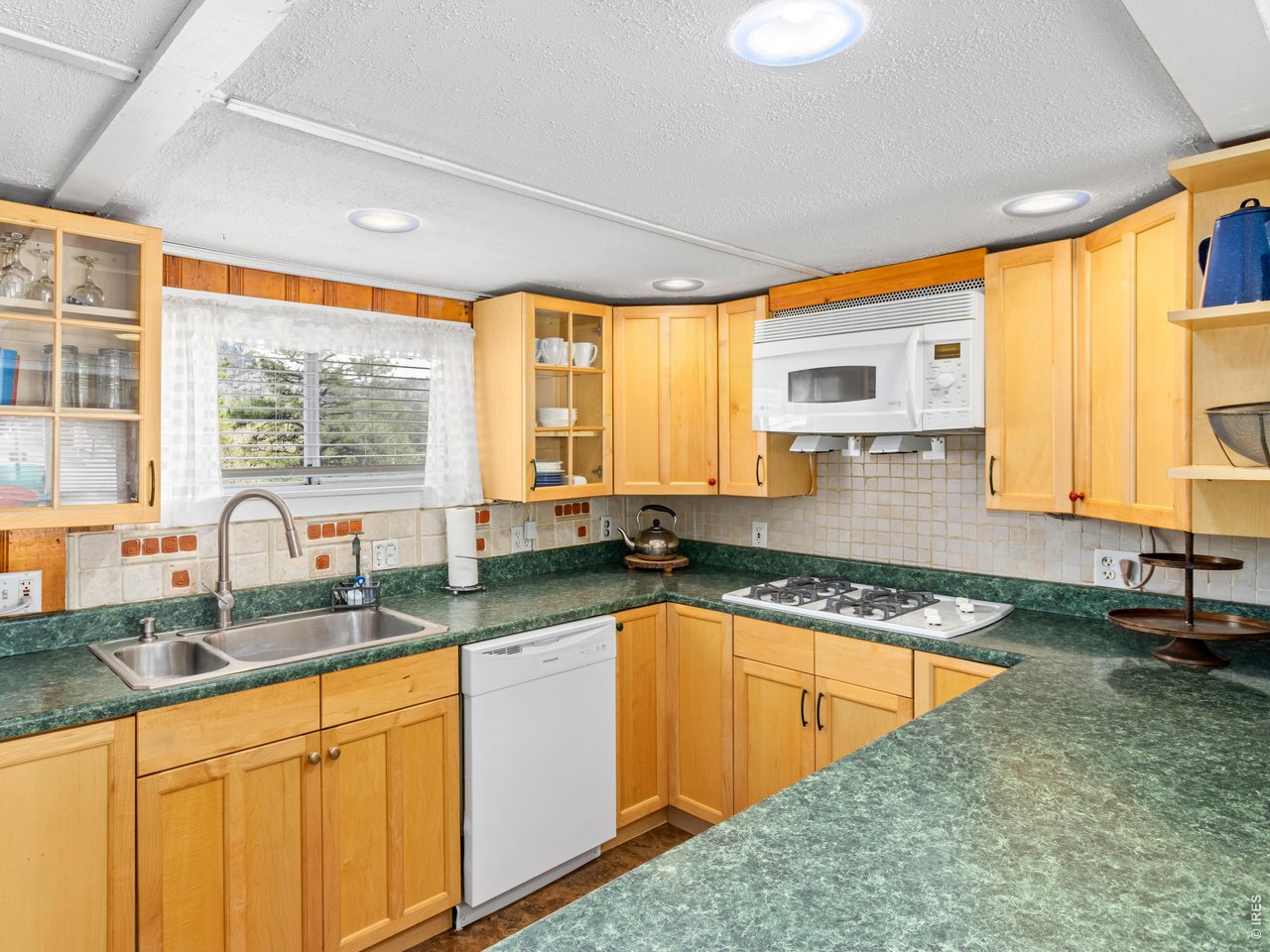2242 Eagle Cliff Road Estes Park, CO 80517 - Photo 10 of 22 a kitchen with granite countertop a sink a counter top space and living room area