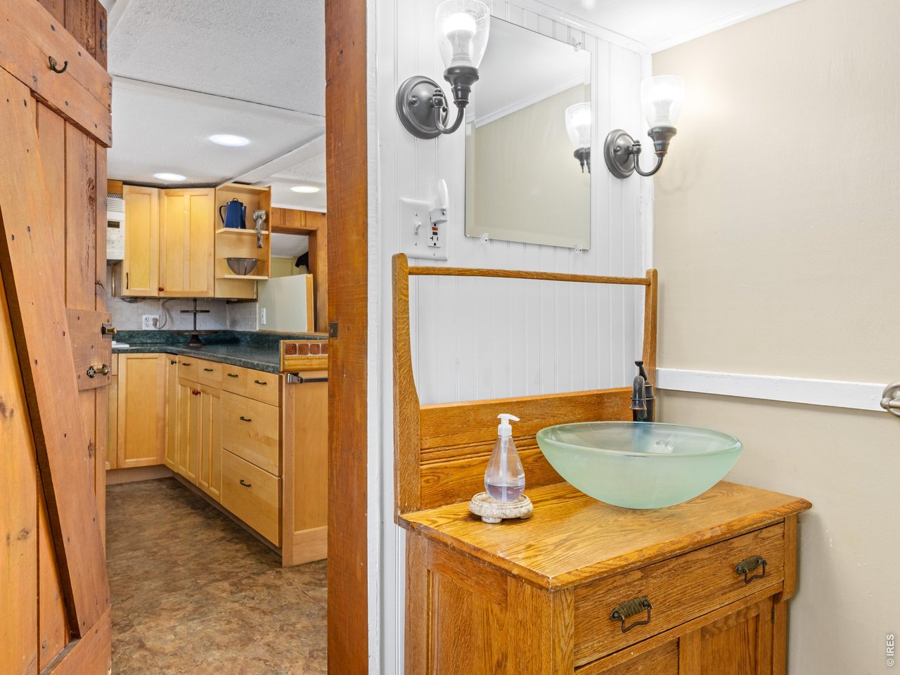 2242 Eagle Cliff Road Estes Park, CO 80517 - Photo 12 of 22 a bathroom with a granite countertop sink and a mirror