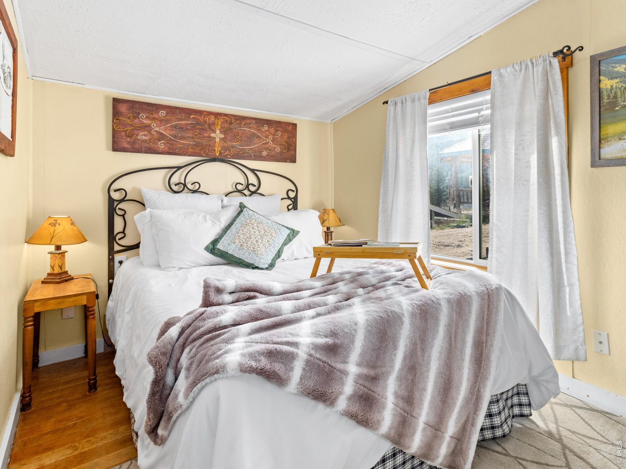 2242 Eagle Cliff Road Estes Park, CO 80517 - Photo 13 of 22 a bedroom with a bed and a window