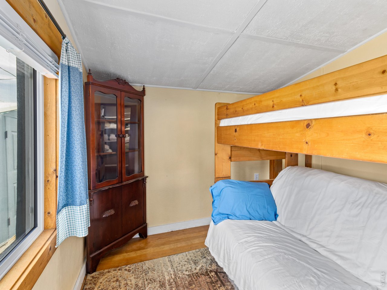 2242 Eagle Cliff Road Estes Park, CO 80517 - Photo 15 of 22 a bedroom with a bed and wooden floor