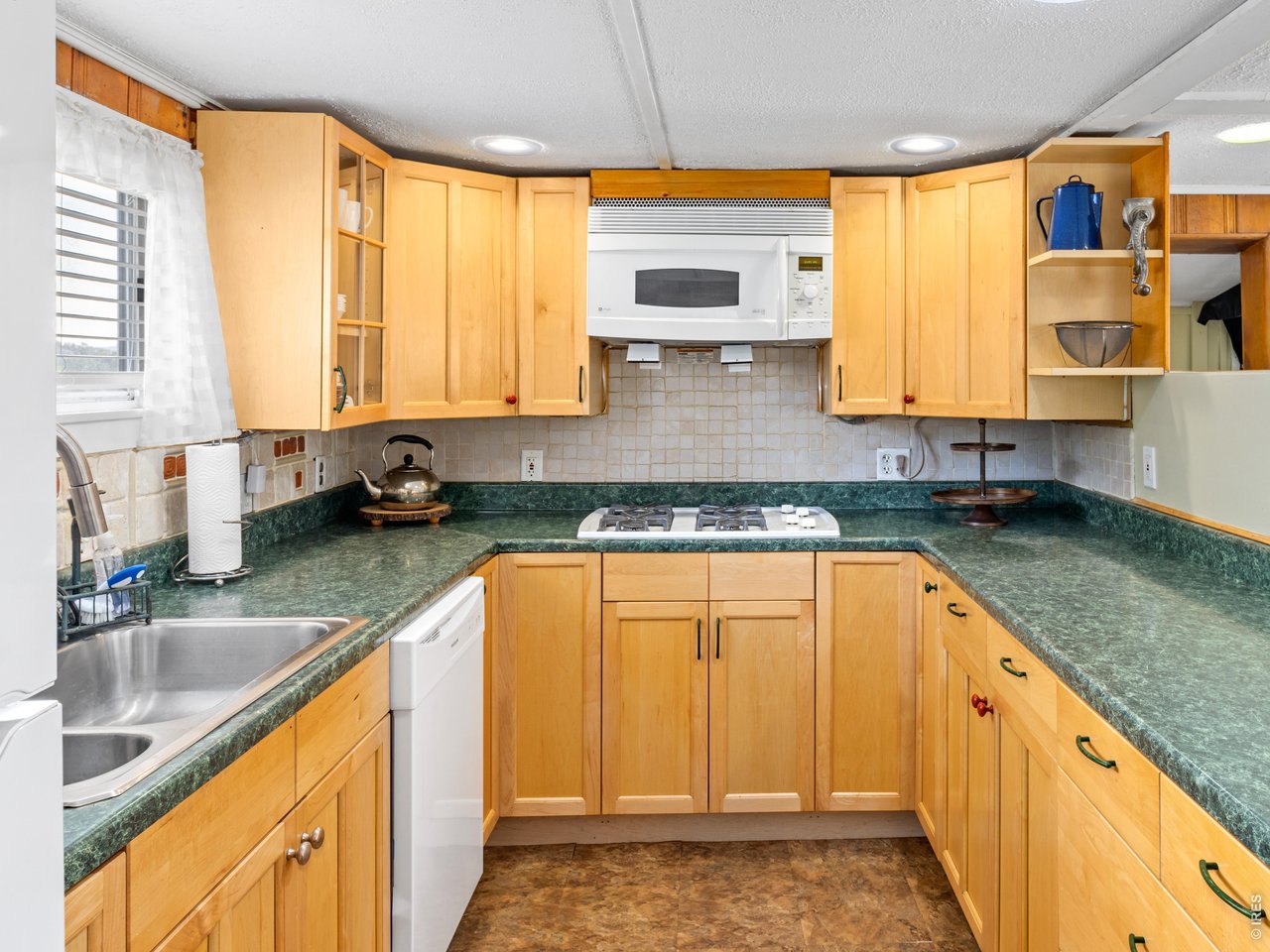 2242 Eagle Cliff Road Estes Park, CO 80517 - Photo 8 of 22 a kitchen with stainless steel appliances granite countertop sink and cabinets