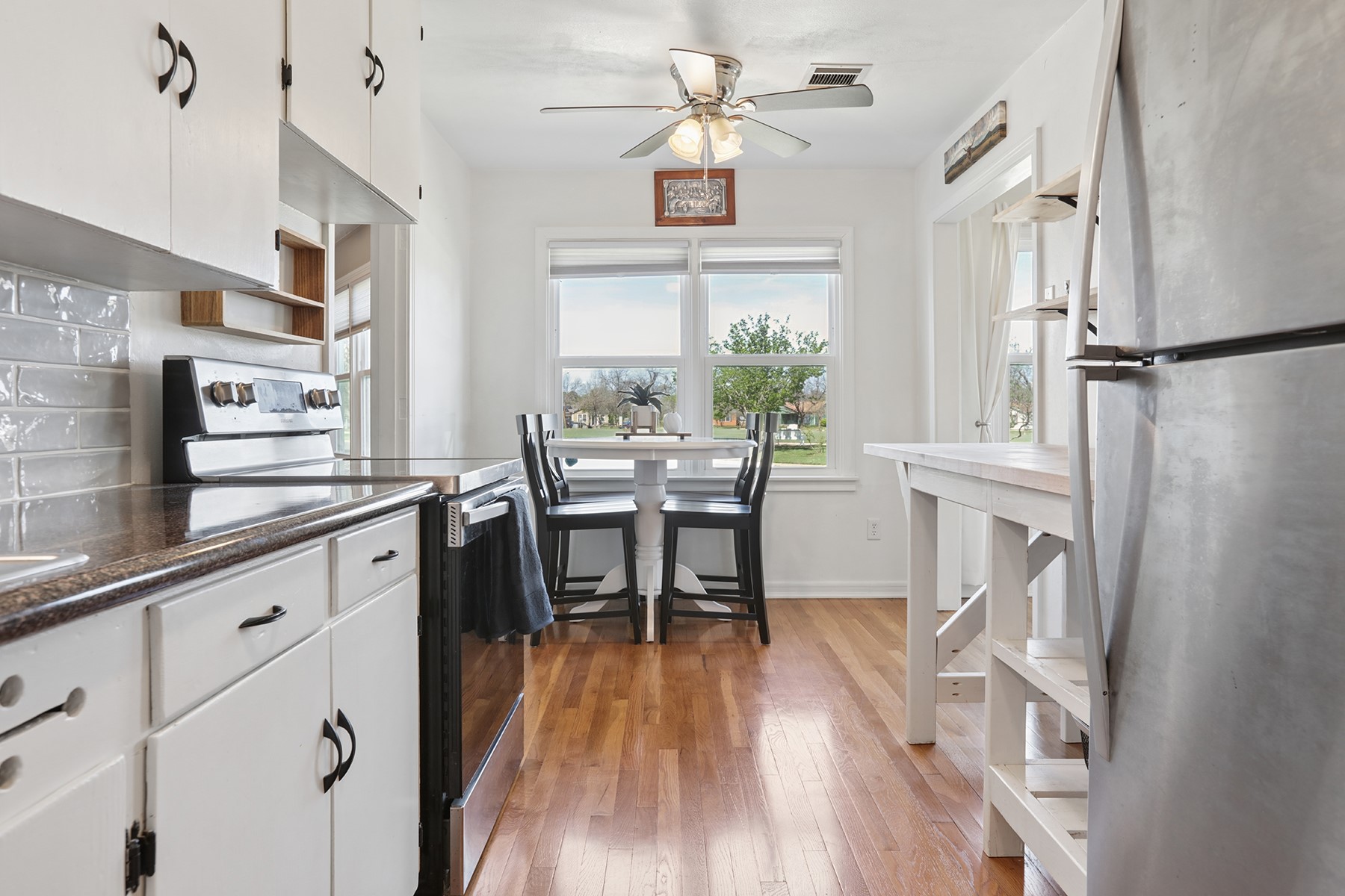 2210 Monticello Road Temple, TX 76501 - Photo 19 of 34 Kitchen featuring white cabinetry, stainless steel appliances, light wood-style floors, open shelves, and a ceiling fan