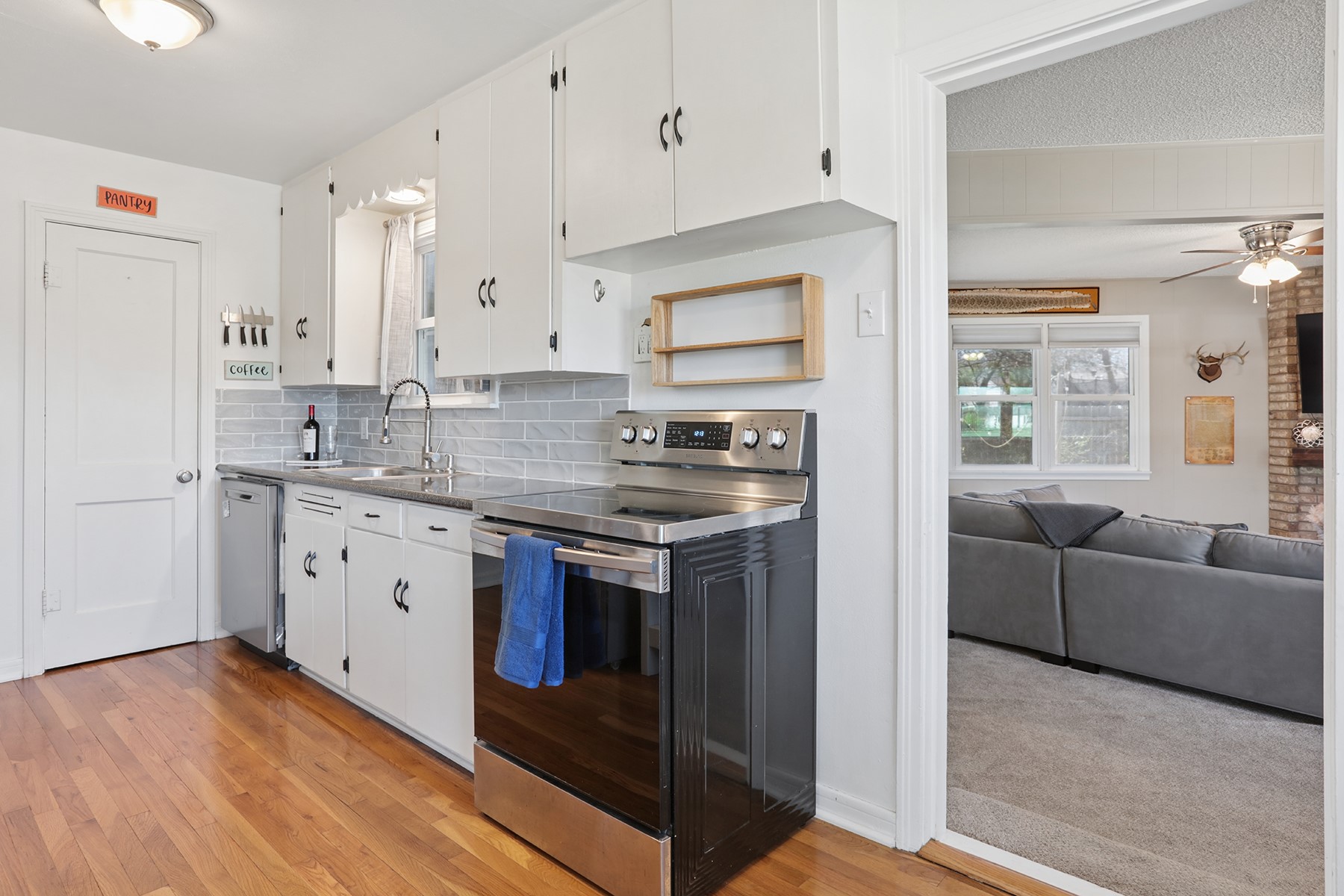 2210 Monticello Road Temple, TX 76501 - Photo 21 of 34 Kitchen with stainless steel appliances, white cabinetry, a ceiling fan, and backsplash
