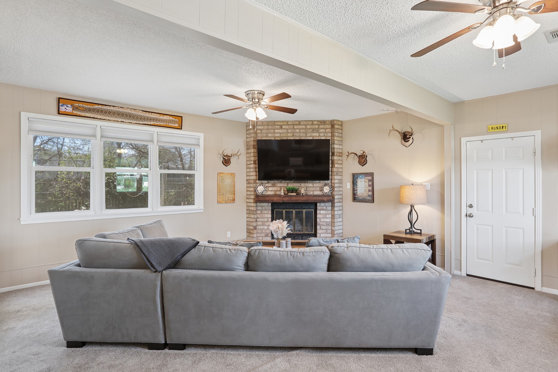 2210 Monticello Road Temple, TX 76501 - Photo 23 of 34 Living room with a ceiling fan, a textured ceiling, carpet floors, and a fireplace