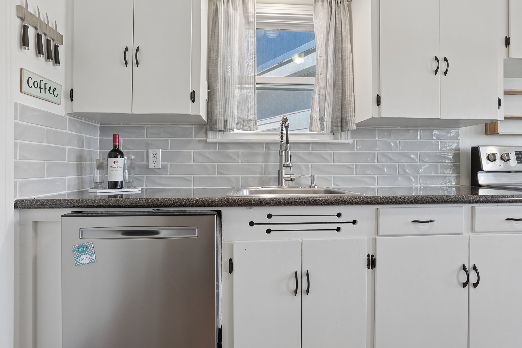 2210 Monticello Road Temple, TX 76501 - Photo 7 of 34 Kitchen with white cabinetry, stainless steel dishwasher, white stove, and range hood