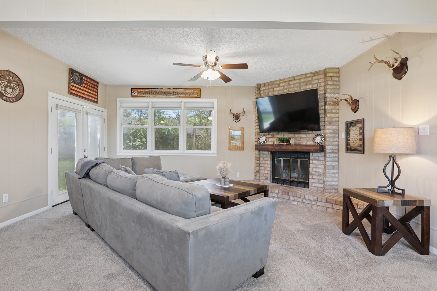 2210 Monticello Road Temple, TX 76501 - Photo 8 of 34 Living area featuring a textured ceiling, ceiling fan, light colored carpet, and a brick fireplace
