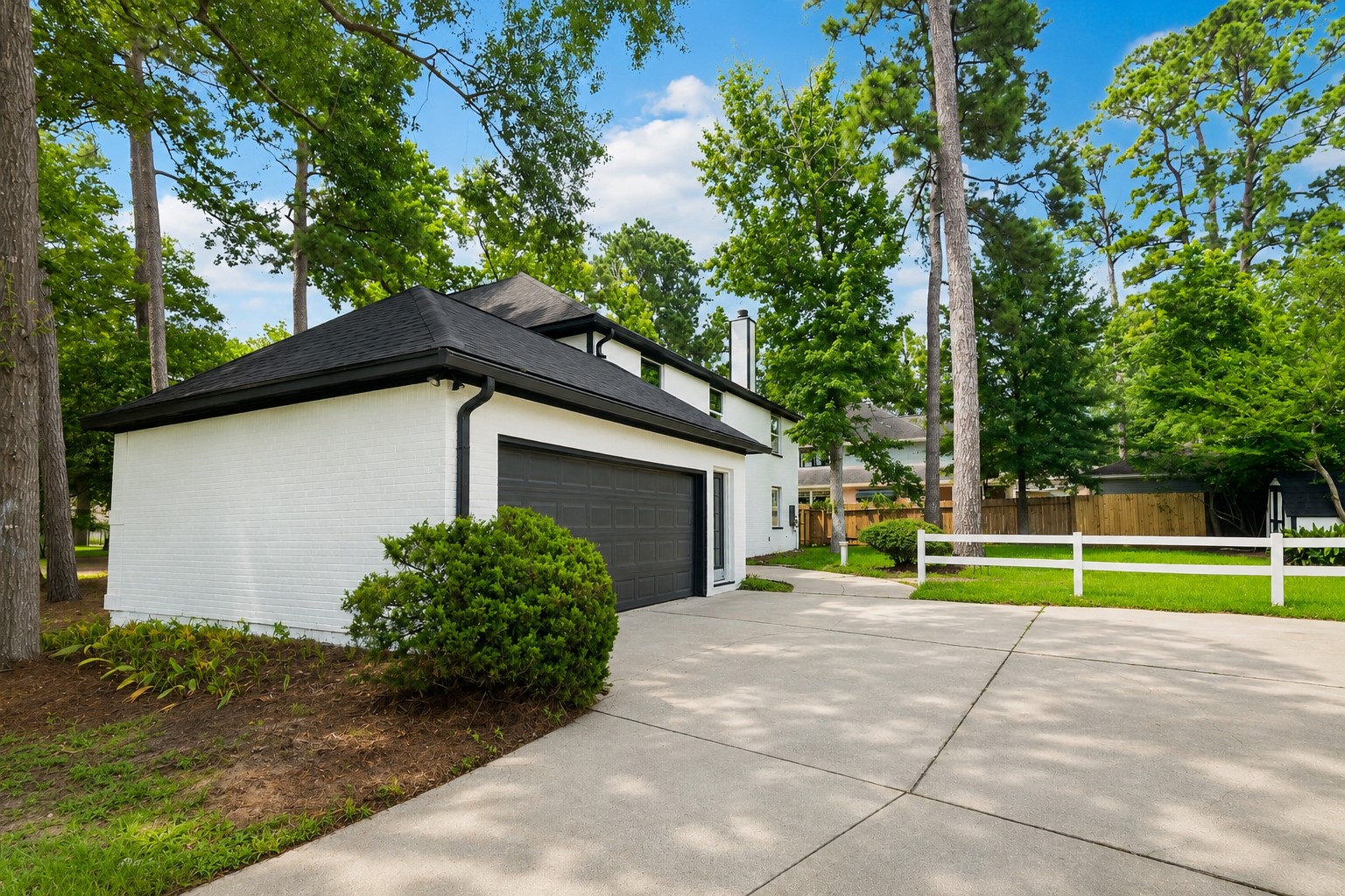 523 Rampart Lane Conroe, TX 77302 - Photo 29 of 41 Updated exterior with painted brick, oversized driveway, mature trees, and beautiful golf course community surroundings.