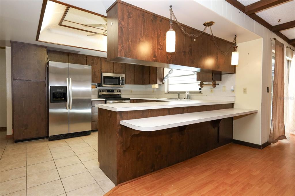 504 Ridgewood Street Altamonte Springs, FL 32701 - Photo 14 of 51 a kitchen with stainless steel appliances granite countertop a sink stove and refrigerator