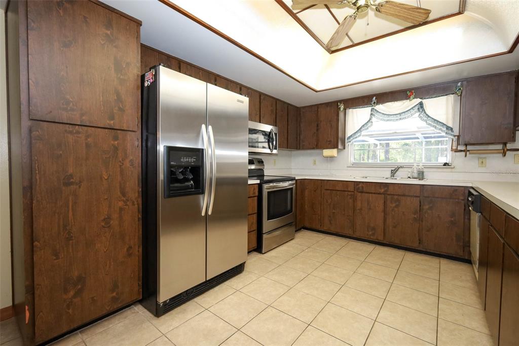 504 Ridgewood Street Altamonte Springs, FL 32701 - Photo 15 of 51 a kitchen with stainless steel appliances granite countertop a refrigerator and a sink