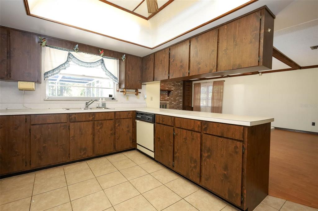 504 Ridgewood Street Altamonte Springs, FL 32701 - Photo 17 of 51 a kitchen with stainless steel appliances a sink window and cabinets
