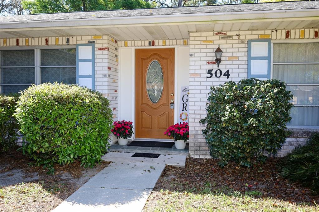 504 Ridgewood Street Altamonte Springs, FL 32701 - Photo 2 of 51 a bunch of flowers in front of a door