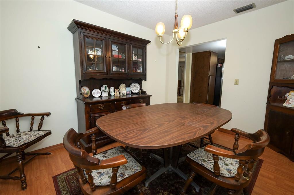 504 Ridgewood Street Altamonte Springs, FL 32701 - Photo 5 of 51 a view of a dining room with furniture and chandelier