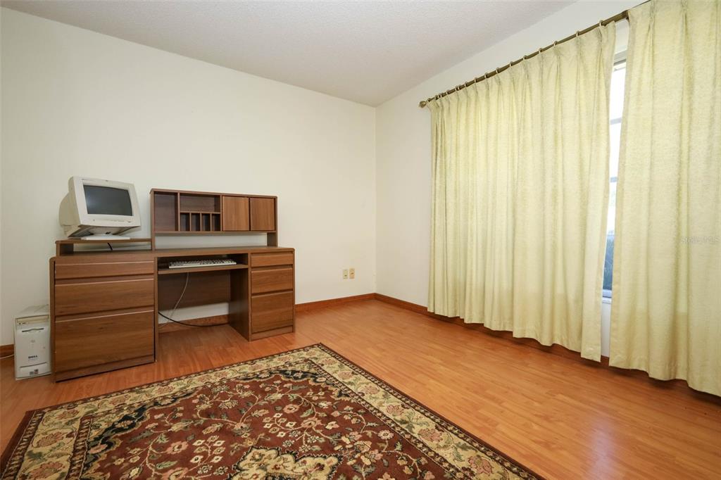 504 Ridgewood Street Altamonte Springs, FL 32701 - Photo 7 of 51 a view of a bedroom with workspace and window