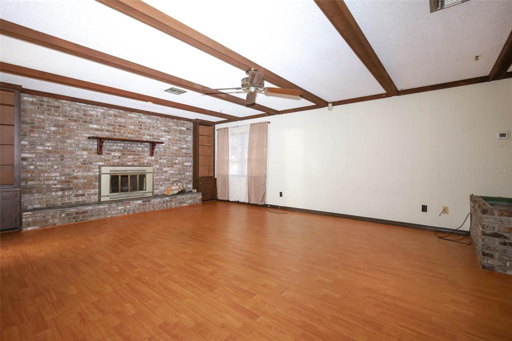 504 Ridgewood Street Altamonte Springs, FL 32701 - Photo 10 of 51 a view of empty room with fireplace and wooden floor