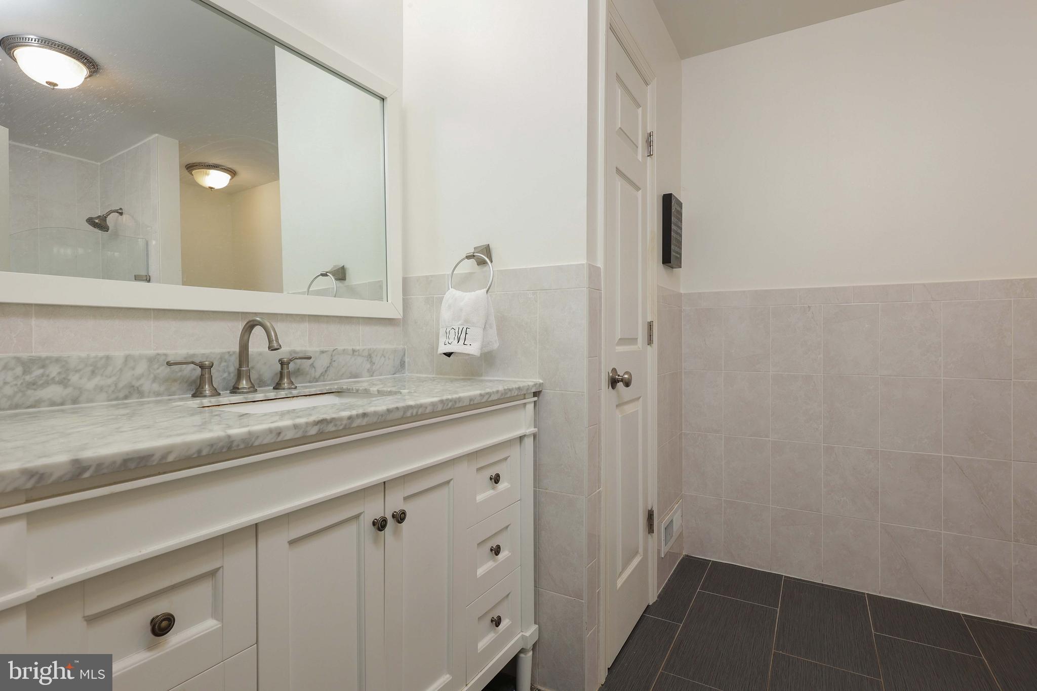 357 Dodds Lane Princeton, NJ 08540 - Photo 17 of 41 a bathroom with a granite countertop sink and a mirror