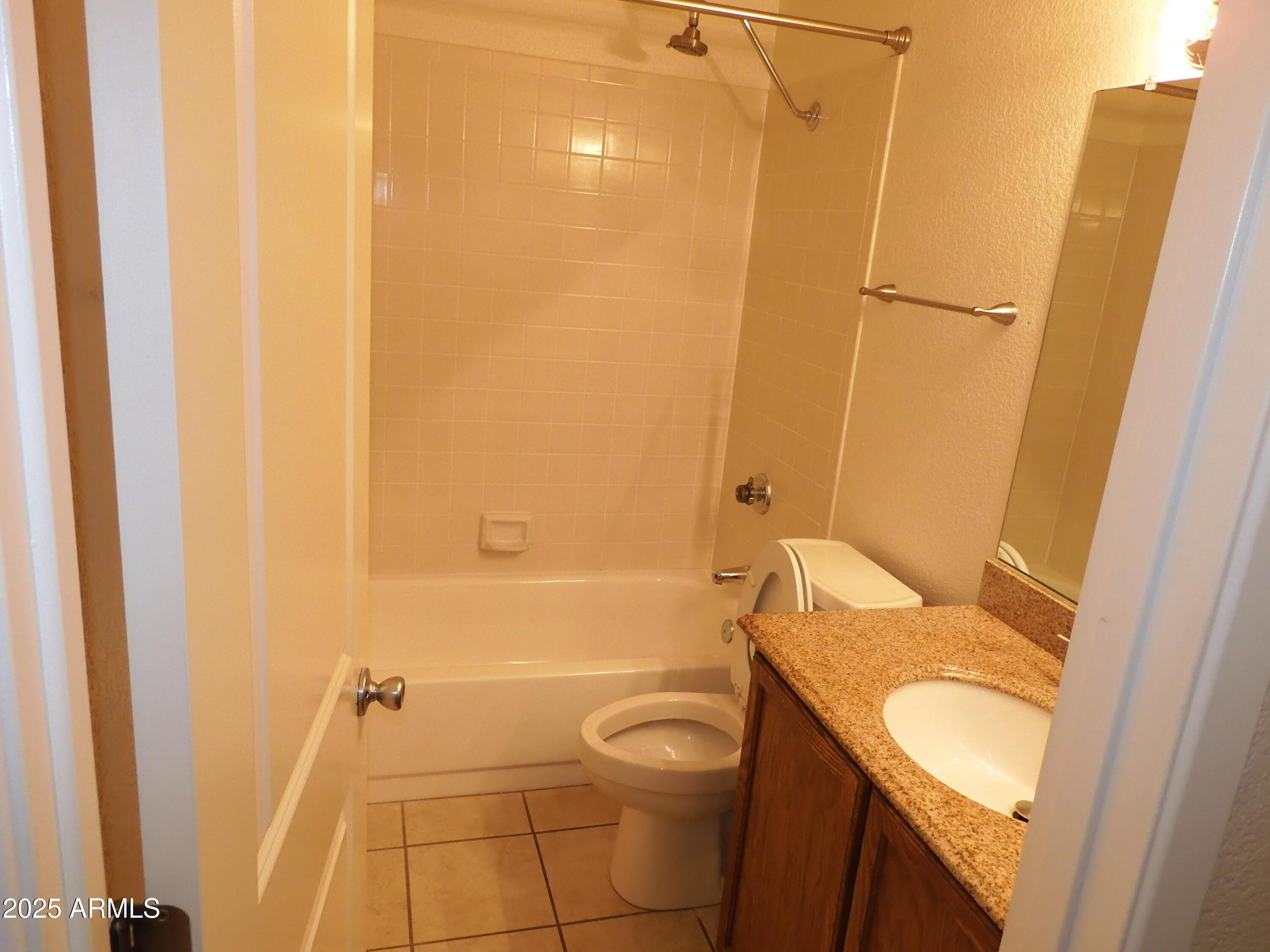 154 West 5th Street, Unit 242 Tempe, AZ 85281 - Photo 15 of 27 a bathroom with a granite countertop sink toilet and shower