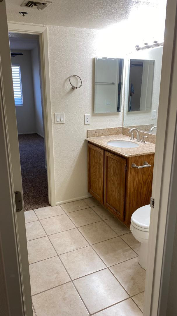 154 West 5th Street, Unit 242 Tempe, AZ 85281 - Photo 21 of 27 a bathroom with a sink a toilet and mirror