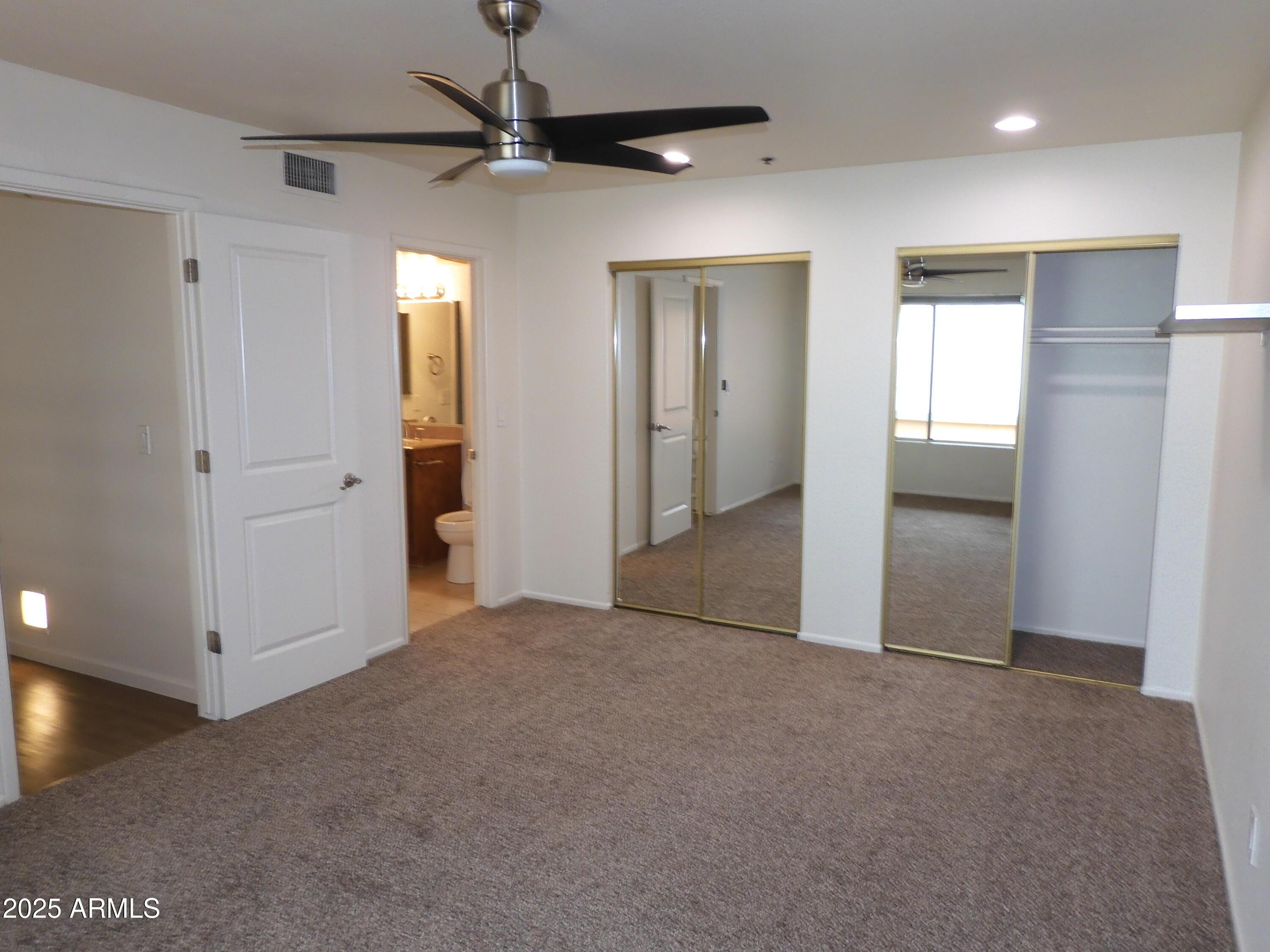 154 West 5th Street, Unit 242 Tempe, AZ 85281 - Photo 4 of 27 an empty room with closet and a chandelier fan