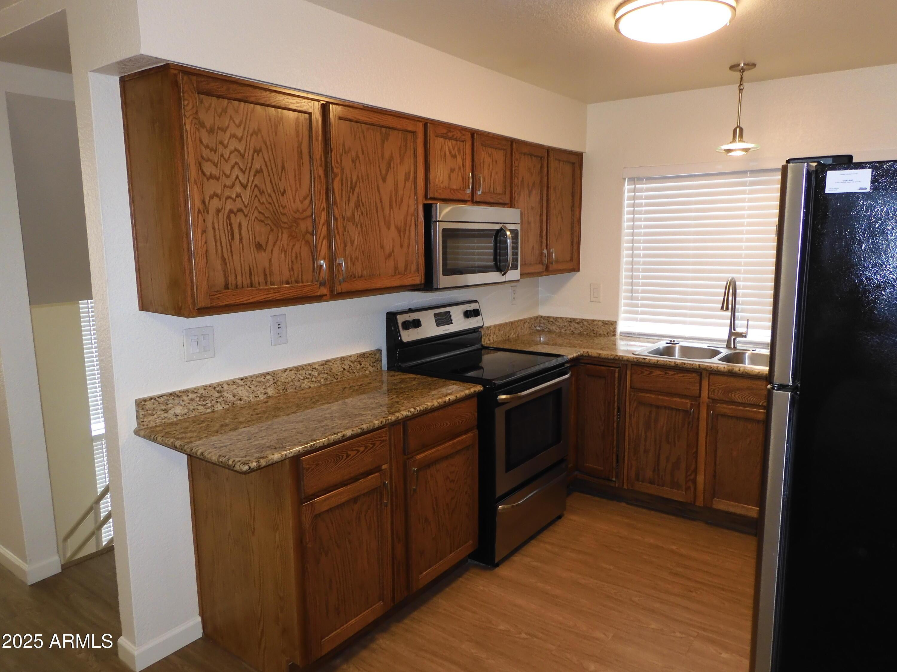 154 West 5th Street, Unit 242 Tempe, AZ 85281 - Photo 10 of 27 a kitchen with a sink stove and microwave