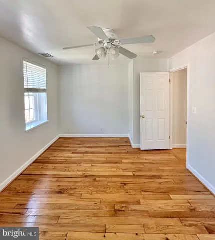 a view of a room with wooden floor and white walls