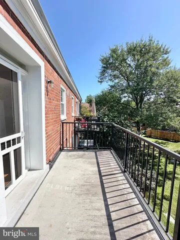 a balcony with wooden floor and city view
