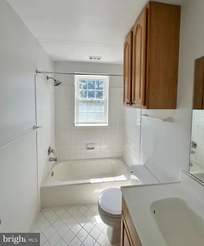 a bathroom with a bathtub and a sink