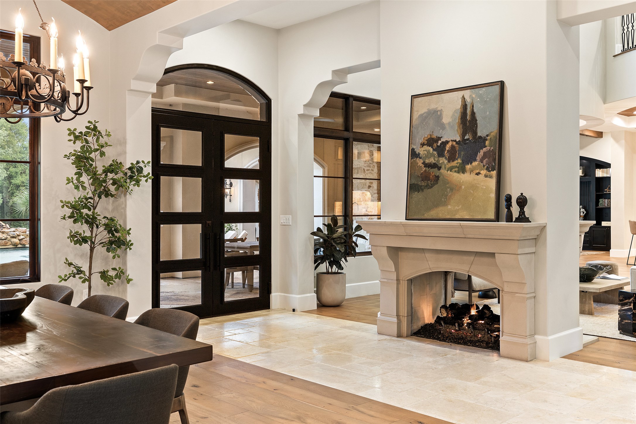 3667 Stoneridge Road Austin, TX 78746 - Photo 9 of 40 Positioned between the living room and dining room, the dual sided fireplace adds warmth while keeping both spaces visually connected.