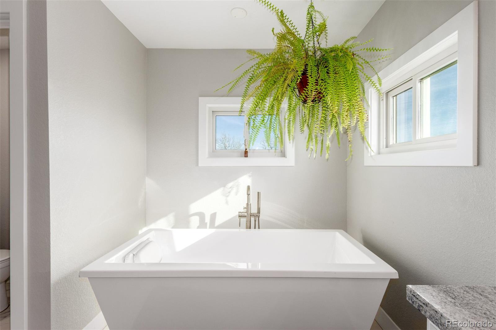 15528 Nancy Avenue Fort Lupton, CO 80621 - Photo 15 of 35 a bathroom with a sink and a window