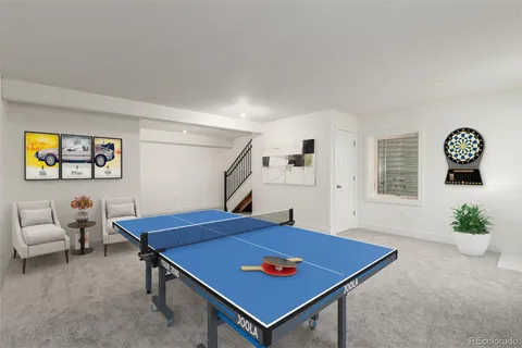 a living room with furniture a flat screen tv and a floor to ceiling window