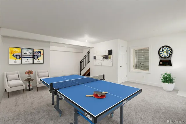 a living room with furniture a flat screen tv and a floor to ceiling window