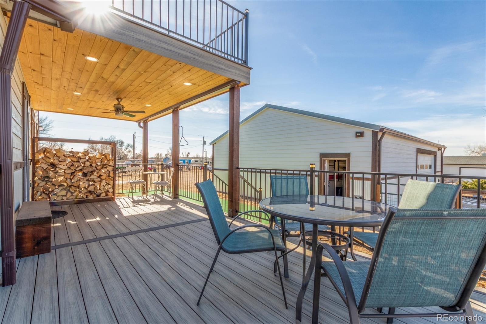 15528 Nancy Avenue Fort Lupton, CO 80621 - Photo 3 of 35 a balcony with furniture and wooden floor