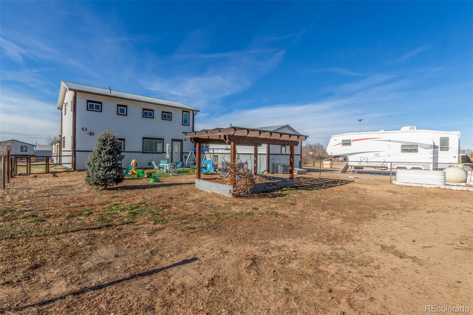 15528 Nancy Avenue Fort Lupton, CO 80621 - Photo 31 of 35 a view of a house with backyard