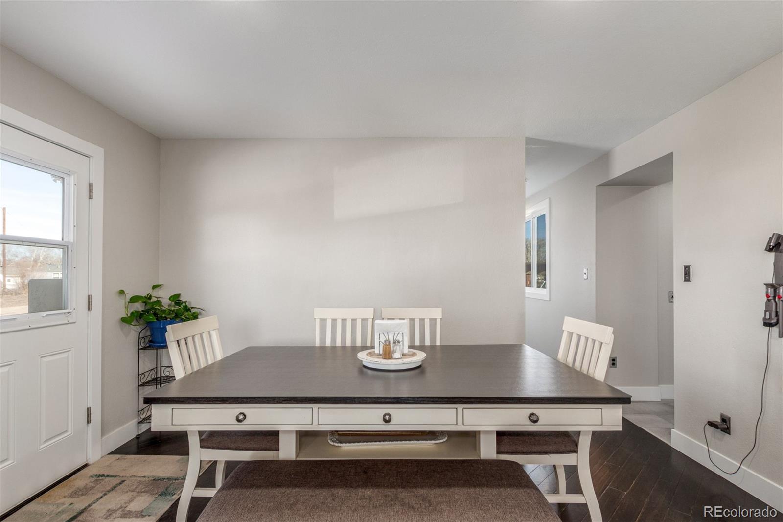 15528 Nancy Avenue Fort Lupton, CO 80621 - Photo 7 of 35 a view of a dining room with furniture and wooden floor