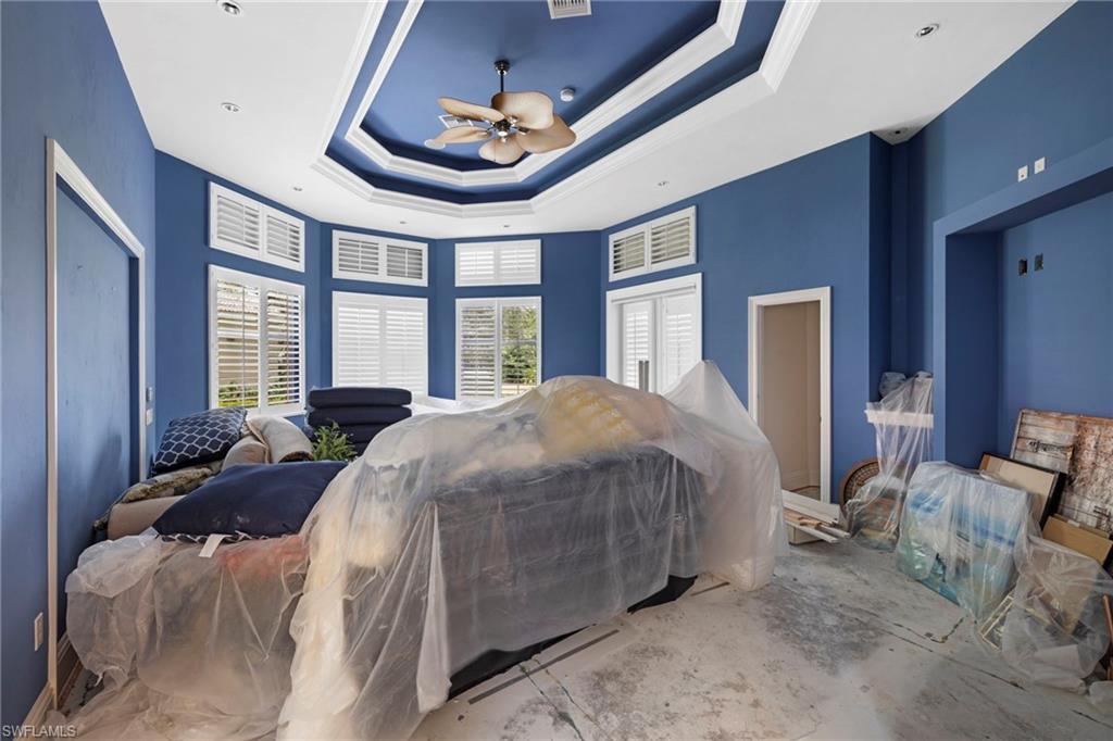 7834 Classics Drive Naples, FL 34113 - Photo 19 of 37 a spacious bedroom with a bed and large windows