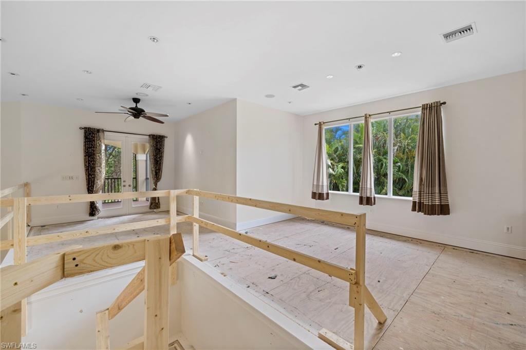 7834 Classics Drive Naples, FL 34113 - Photo 24 of 37 a large white room with a large window and sink