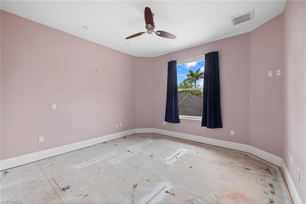 7834 Classics Drive Naples, FL 34113 - Photo 26 of 37 a view of an empty room with window and ceiling fan