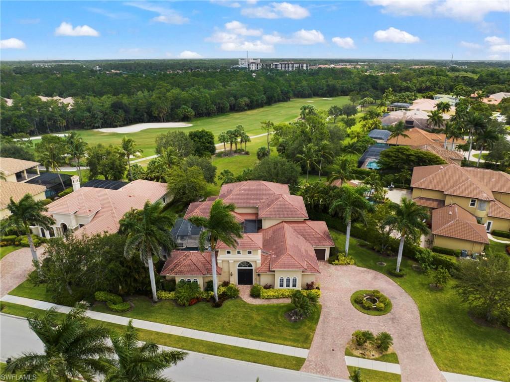 7834 Classics Drive Naples, FL 34113 - Photo 32 of 37 an aerial view of a house with garden space and outdoor seating