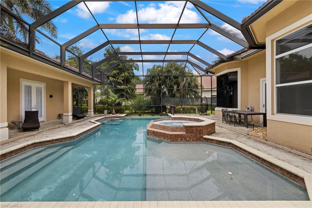 7834 Classics Drive Naples, FL 34113 - Photo 4 of 37 a view of a white building with swimming pool in front of it