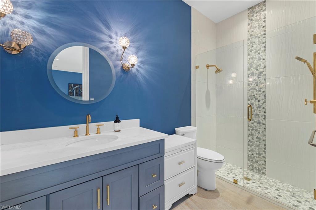 7834 Classics Drive Naples, FL 34113 - Photo 6 of 37 a bathroom with a toilet a sink and mirror