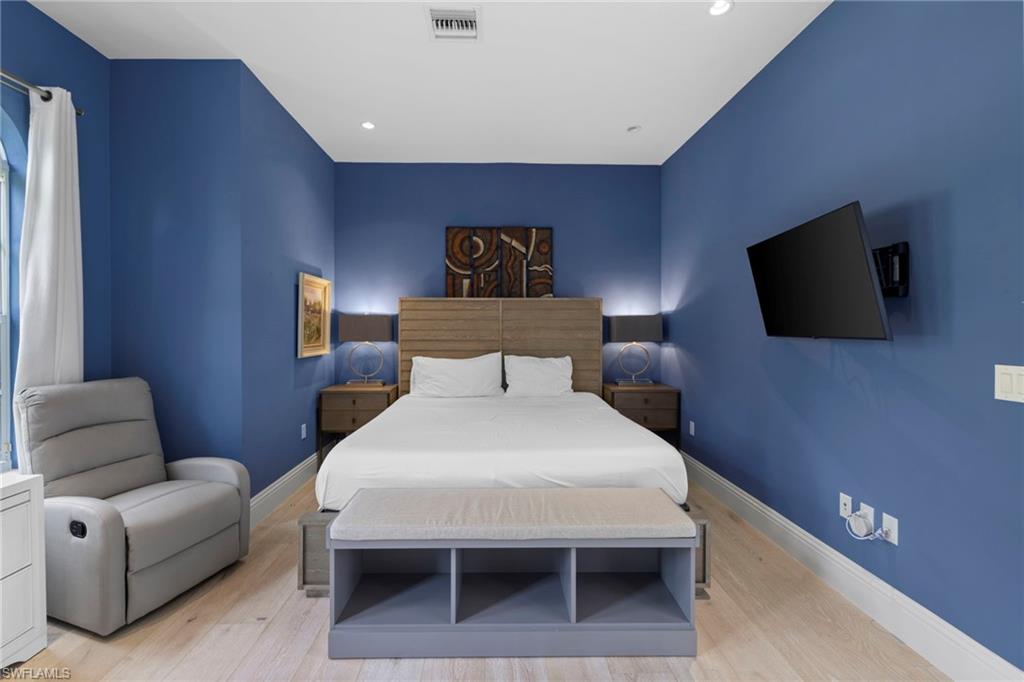 7834 Classics Drive Naples, FL 34113 - Photo 8 of 37 a bedroom with a bed and a flat screen tv