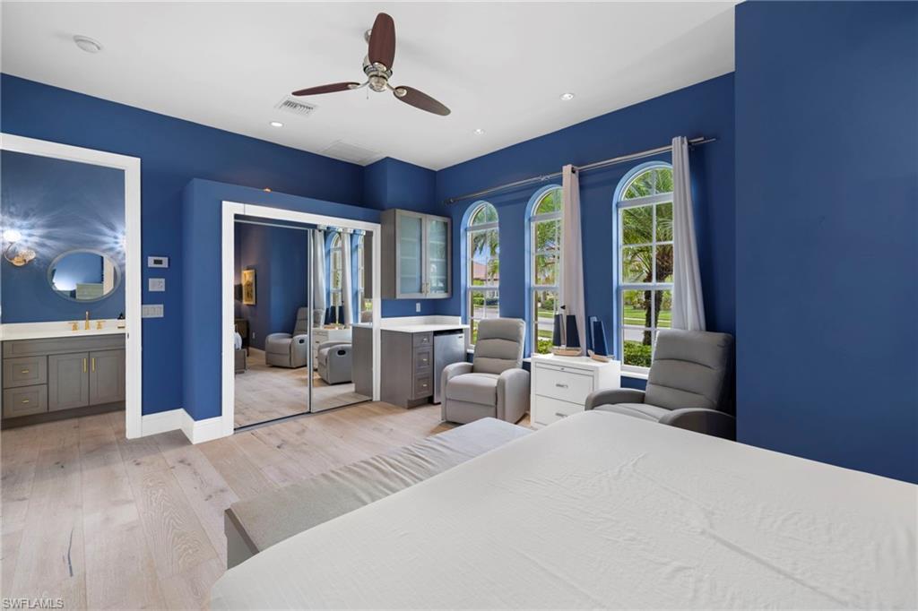 7834 Classics Drive Naples, FL 34113 - Photo 9 of 37 a bedroom with a large bed and a large window