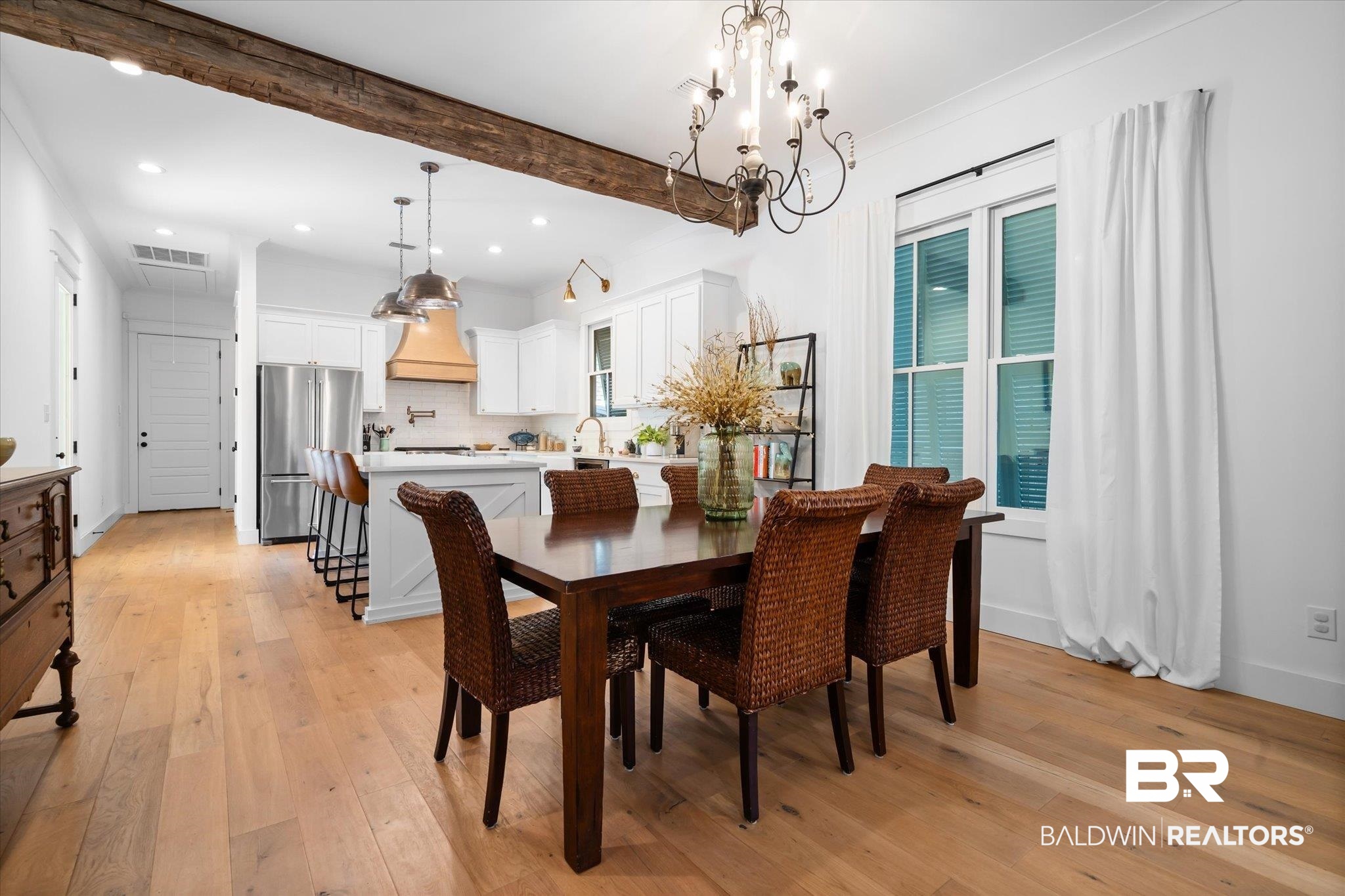 15 Semmes Avenue Mobile, AL 36604 - Photo 9 of 43 Dining room with beam ceiling, light hardwood / wood-style floors, sink, and an inviting chandelier