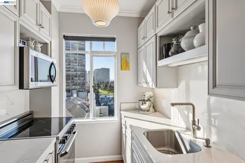 a kitchen with stainless steel appliances granite countertop a sink stove and cabinets