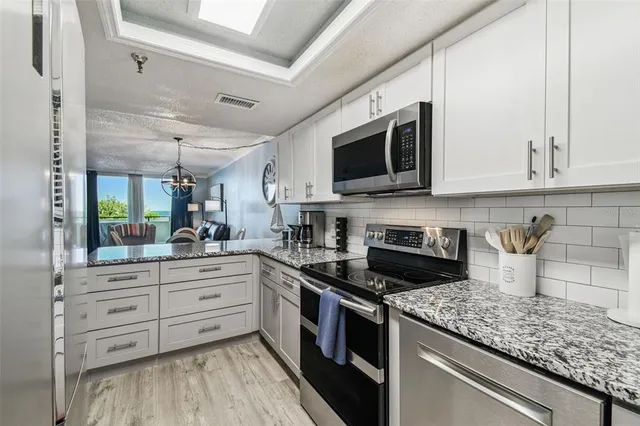 a living room with furniture a mirror and a large window